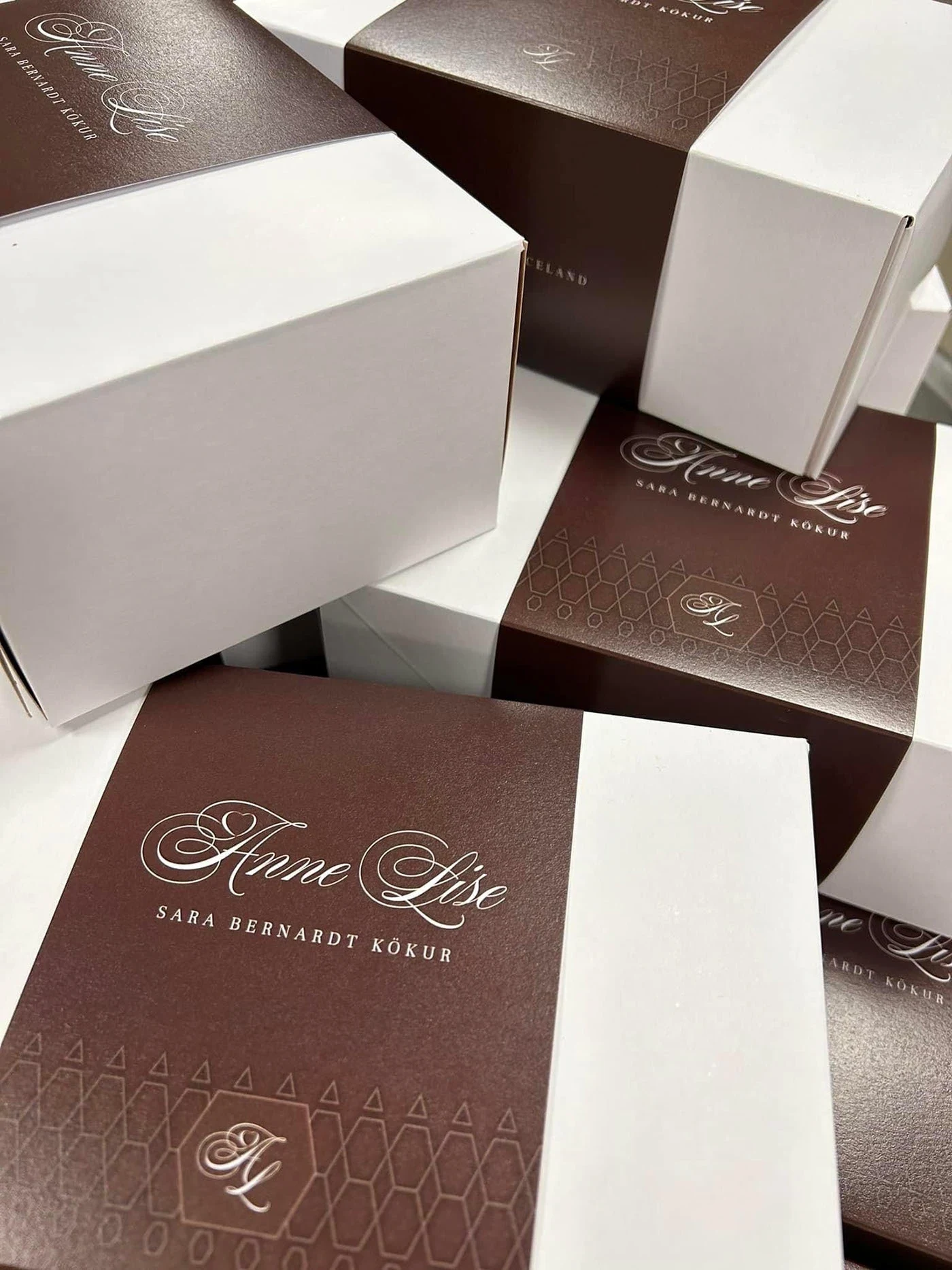 A second packaging view, showing the monogram, sleeves and product names.