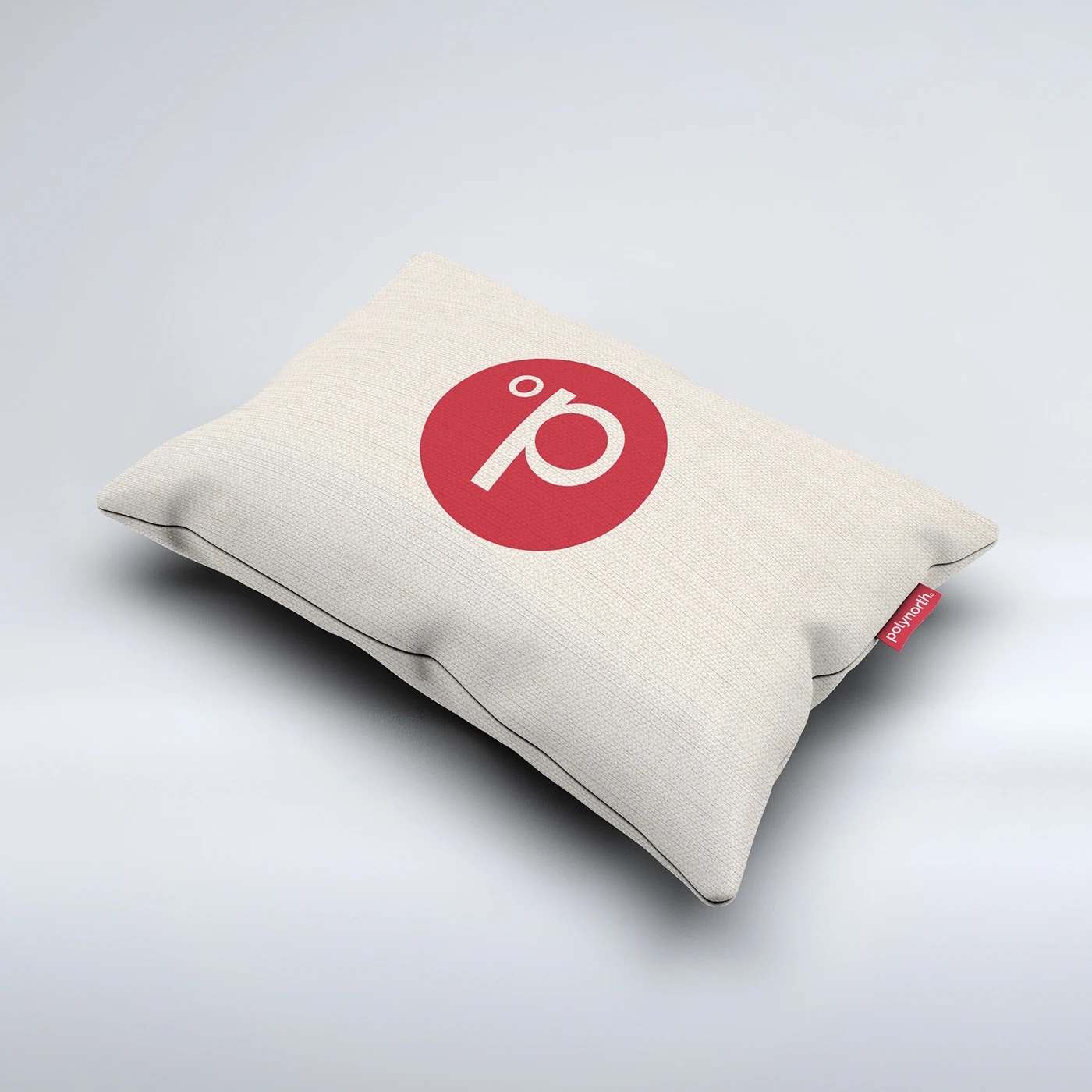 Polynorth red identity symbol on a cream cushion with a branded fabric label